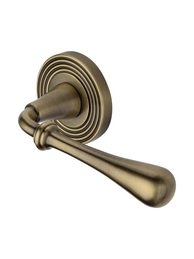 Heritage Brass Door Handle Lever Latch on Round Rose Roma Reeded Design Antique Brass finish
UK Registered Design Number 6226296