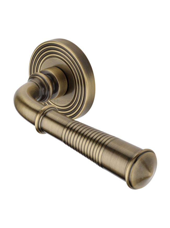 Heritage Brass Door Handle Lever Latch on Round Rose Bridgetown Reeded Design Antique Brass finish
UK Registered Design Number 6226297